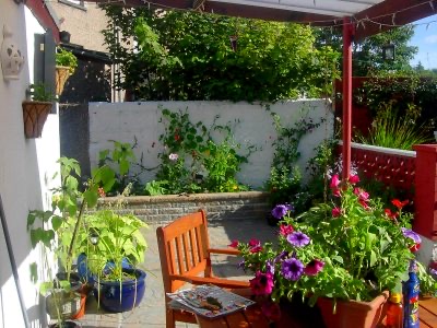Planted patio with a chair and colourful pots