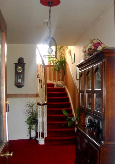 Interior hallway and red-carpeted stairs